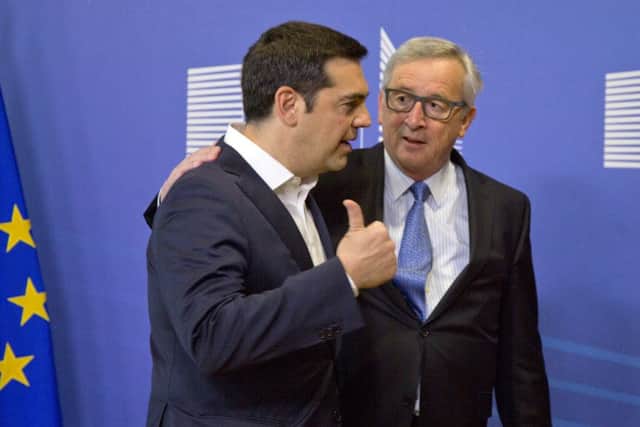 Greek Prime Minister Alexis Tsipras, left, speaks with European Commission President Jean-Claude Juncker in Brussels on Monday. Picture: AP