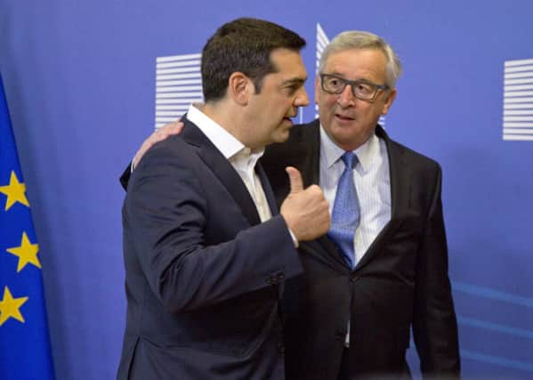 Greek Prime Minister Alexis Tsipras, left, speaks with European Commission President Jean-Claude Juncker in Brussels on Monday. Picture: AP