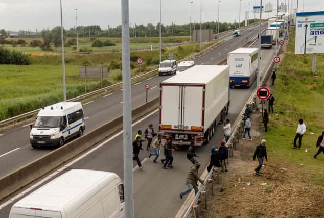 Migrants walk on the A16 highway as they try to access the Channel Tunnel on June 23, 2015 in Calais, northern France. AFP PHOTO PHILIPPE HUGUENPHILIPPE HUGUEN/AFP/Getty Images