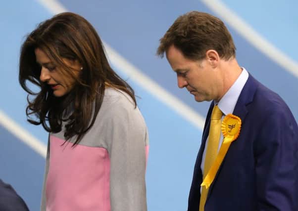 Nick Clegg and his wife Miriam Gonzalez Durantez look dejected as the scale of the Lib Dem debacle emerges. Picture: Getty Images