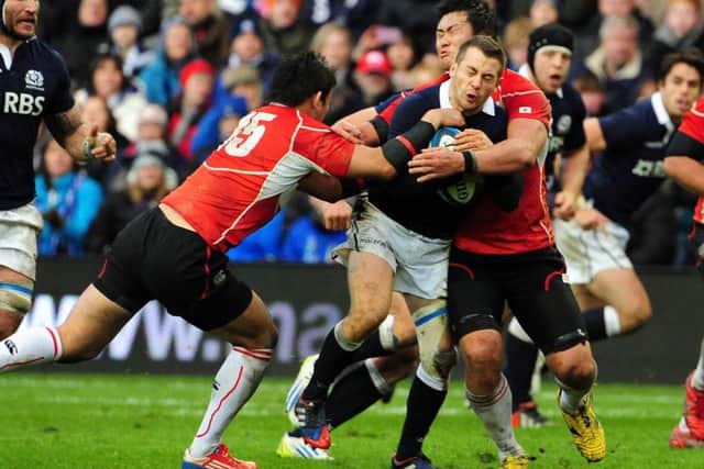 Greig Laidlaw is tackled by Ayumu Goromaru and Shinya Makabe the last time Scotland met Japan, a 42-17 home win at Murrayfield in November 2013. Picture: Ian Rutherford