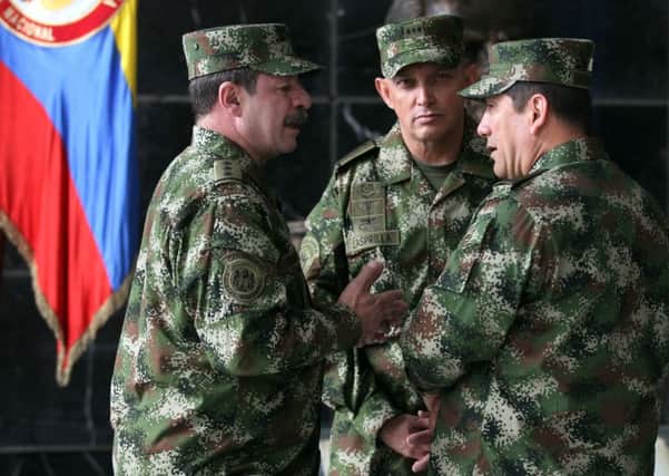 Colombian armed forces commander General Juan Pablo Rodriguez, right, and army commander Gen Jaime Lasprilla, centre, were implicated in deaths. Picture: AP