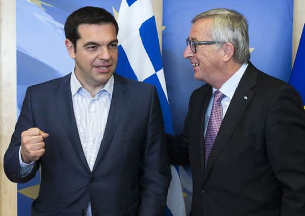 Greek prime minister Alexis Tsipras, left, was in further talks with European Commission President Jean-Claude Juncker in Brussels last night. Picture: AP