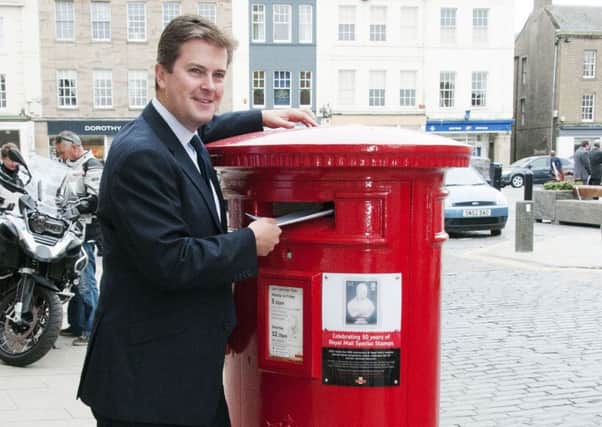 Matthew Maxwell Scott, a direct descendent of Sir Walter Scott, as he unveils a stamp plaque of Sir Walter Scott on a postbox in Kelso. Picture: PA