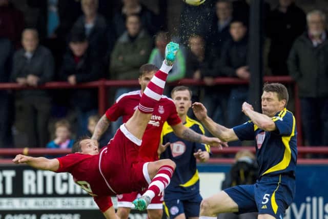 Aberdeens Peter Pawlett in acrobatic action as Darren Dods moves in to challenge. Picture: SNS Group