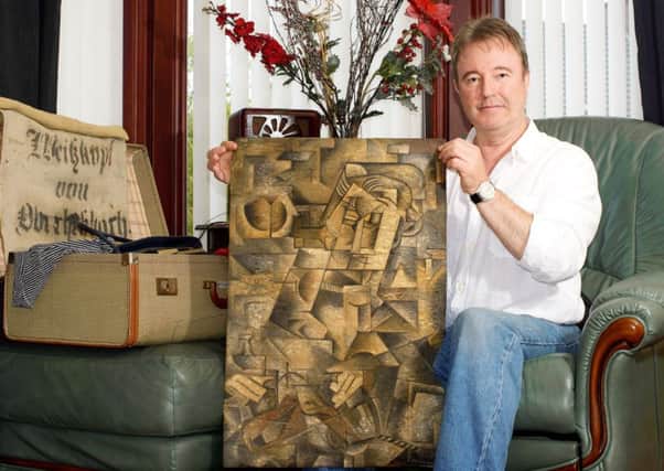 Dominic Currie with the painting he found in his dead mother's suitcase. Picture: Hemedia