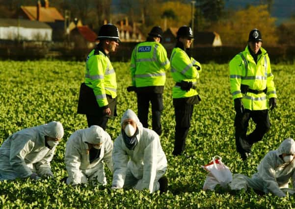 Police watch as protesters tear up genetically modified oil seed rape at a farm in Warwickshire at the height of the GM controversy. Picture: Getty
