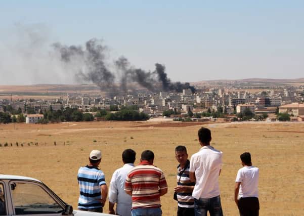 Smoke rises from the town of Kobani on the Syrian border with Turkey as IS extremists return after being expelled in January. Picture: AFP/Getty Images