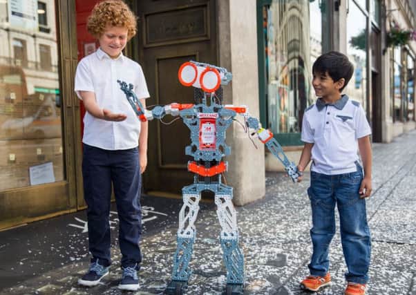 Children play with a hitech robot outside Hamleys. Picture: Getty