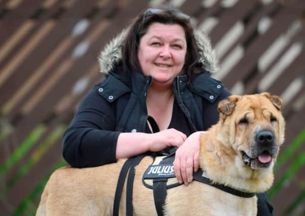 Kai the Shar-Pei with its carer Laura Cumming, from Saltcoats, Ayrshire, Scotland, after it was found in Hungary. Picture: Hemedia