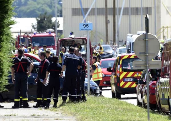 French police and firefighters gather at the entrance of the Air Products company in Saint-Quentin-Fallavier. Picture: Getty