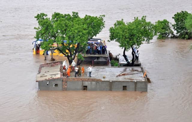 Villagers wait to be rescued in Amreli district which had been suffering a drought until the rains hit. Picture: Getty