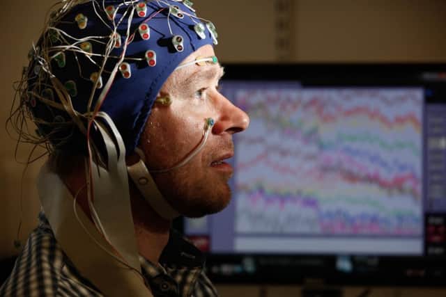 Festival Chorus member Nick Balneaves with his EEG scan on his head, which will gather data to be beamed on to the Usher Hall. Picture: Eoin Carey