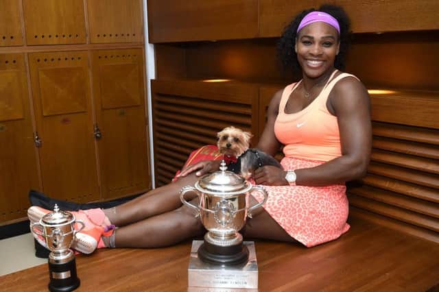 Serena Williams with her dog Chip next to the Suzanne Lenglen trophy following her victory at the French Open. Picture: Getty