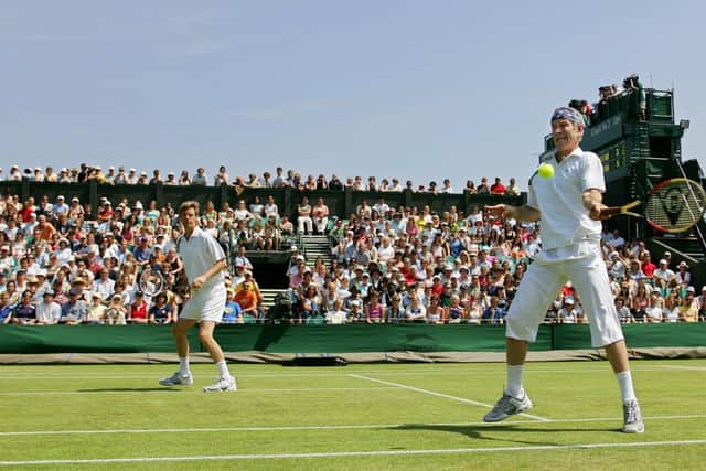 Peter Fleming, left, and John McEnroe in an over-45 doubles match at Wimbledon in 2005. Picture: Getty
