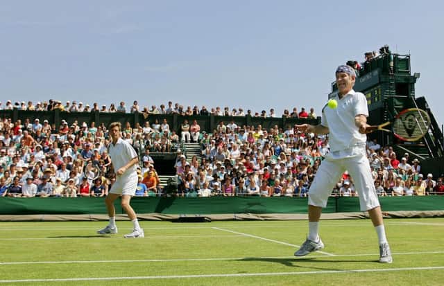 Peter Fleming, left, and John McEnroe in an over-45 doubles match at Wimbledon in 2005. Picture: Getty