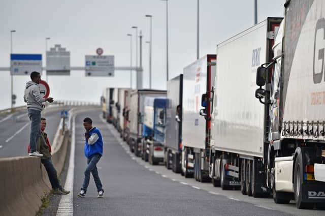Migrants wait to stow away aboard trucks in Calais. Picture: Getty
