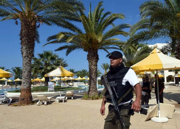 A Tunisian security member stands next to a swimming pool at the resort town of Sousse. Picture: Getty