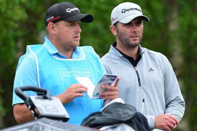 Andrew McArthur consults with his caddie during the second round of the SSE Scottish Hydro Challenge. Picture: Getty