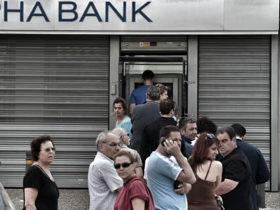 Athens residents queue to withdraw cash. Picture: Getty