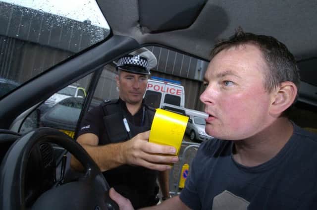 A volunteer takes a breath test for a police campagin against summer drinking and driving. Picture: Julie Bull