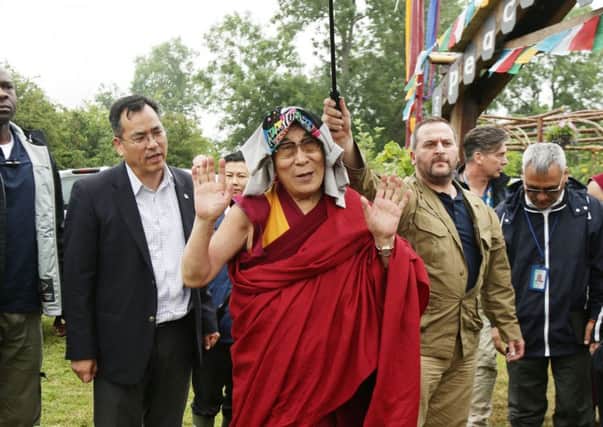 The Dalai Lama arriving in the Stone Circle area of the Glastonbury Festival. Picture: PA