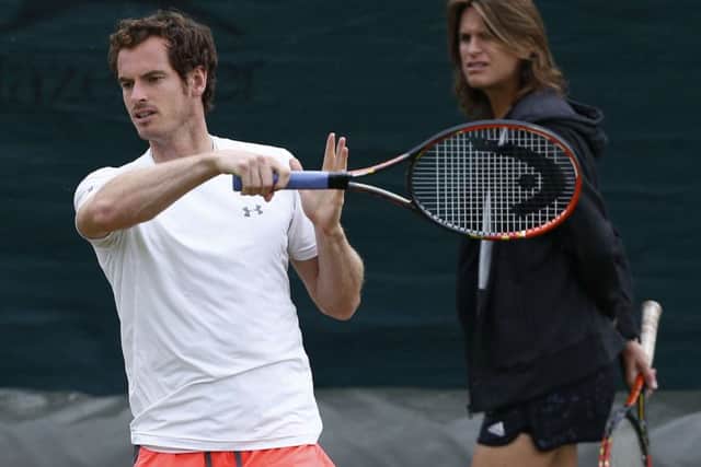 Andy Murray on a practice court under the watchful eye of coach Amelie Mauresmo. Picture: Getty