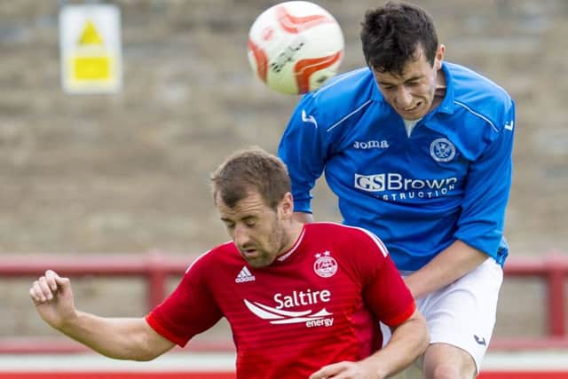 Aberdeens Niall McGinn, left, battles with Joe Shaughnessy, who left Pittodrie for St Johnstone this summer. Picture: SNS