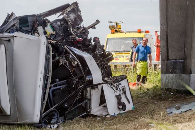 Safety workers attend the bus which crashed on a motorway in Middlekerke, Belgium. Picture: AP