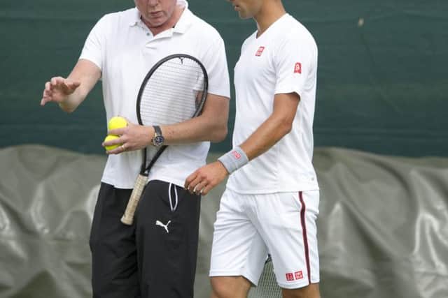Novak Djokovic gets advice from Boris Becker as he prepares to defend his Wimbledon title. Picture: Ian Rutherford