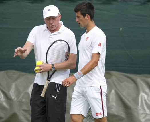 Novak Djokovic gets advice from Boris Becker as he prepares to defend his Wimbledon title. Picture: Ian Rutherford