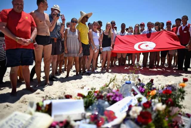 People pay their respects on Marhaba beach where 38 people were killed on Friday. Picture: Getty
