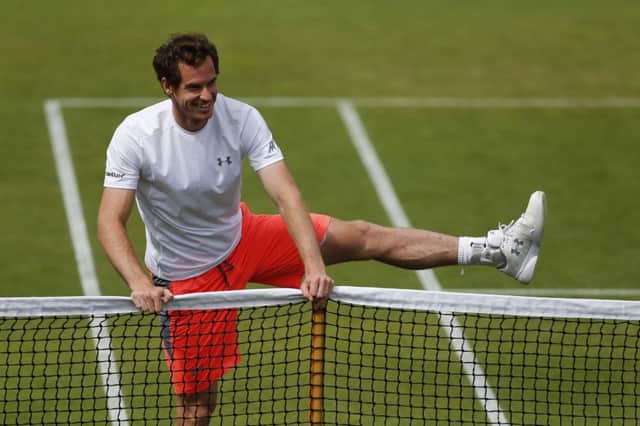 Andy Murray does some exercises on the practice courts at Wimbledon yesterday. Picture: Getty
