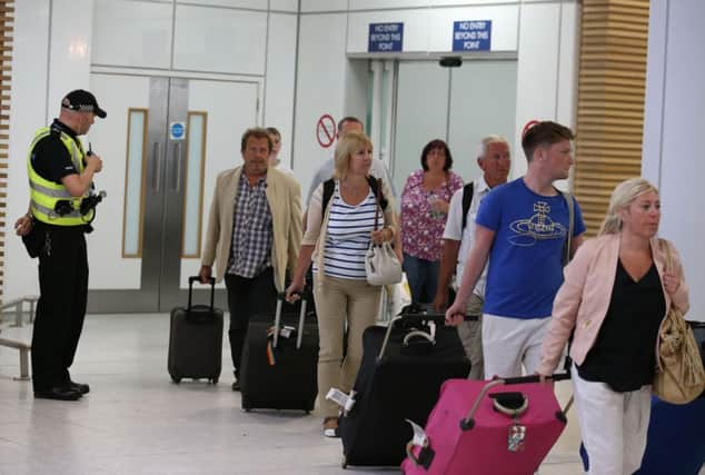 Passengers arrive back at Glasgow Airport from Tunisia yesterday. Picture: PA