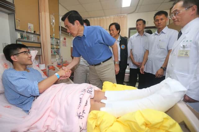 Taiwan president Ma Ying-jeou shakes hands with a victim. Picture: Getty