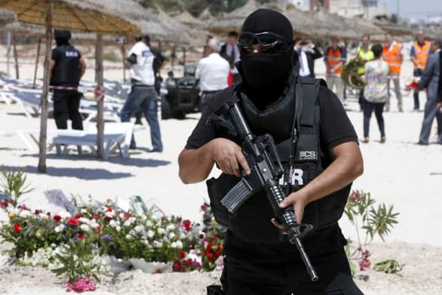 A hooded Tunisian police officer stands guard. Picture: AP