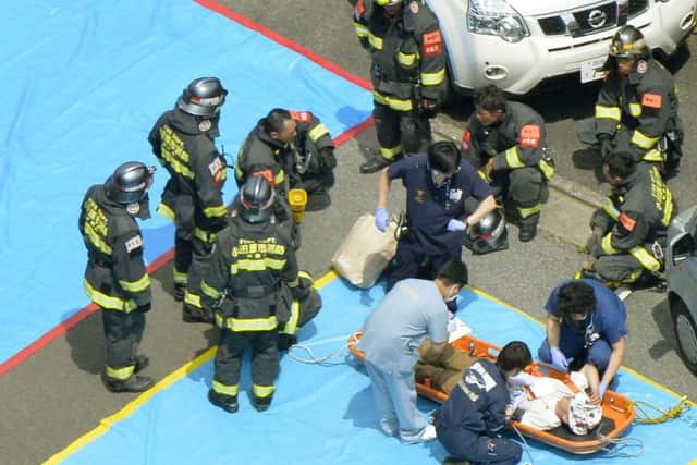 Injured passengers are treated at the scene. Picture: AP/Kyodo News