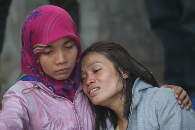 Victims' relatives grieve at a hospital in Medan. Picture: AFP/Getty