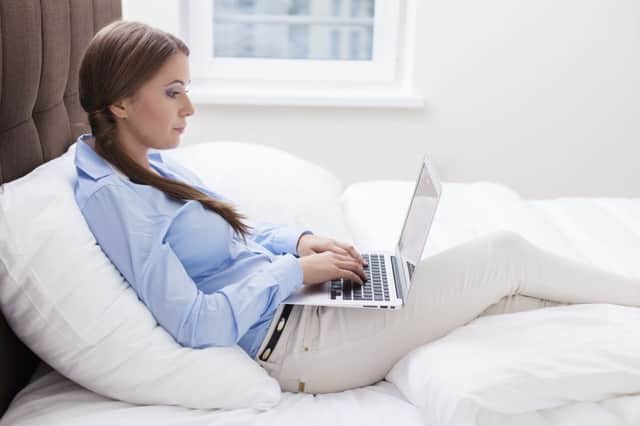 Many home workers prop themselves up on cushions or even in bed. Picture: Getty