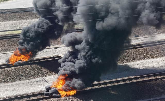 Tyres were strewn across the Channel Tunnel train tracks at Calais and set alight. Picture: AP