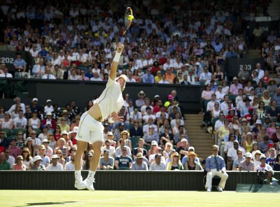 Andy Murray fires down a serve against Mikhail Kukushkin at a sun-baked Wimbledon. Picture: Ian Rutherford
