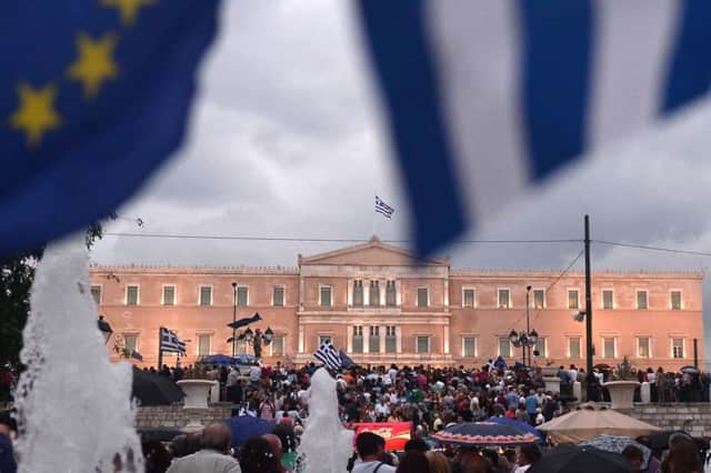 Pro-euro protesters demonstrate in front of the parliament building in Athens. Picture: Getty