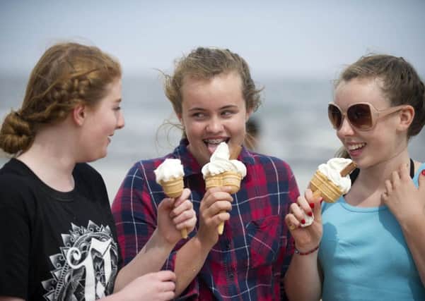 Isobel Rogers, 15, Olivia Sutherland, 14, and Jacqueline Duncan, 15, enjoy ice cream on North Berwick beach, East Lothian. Picture: Jane Barlow
