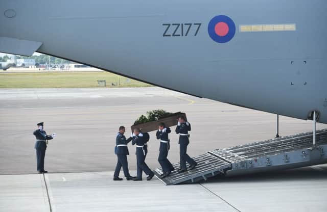 The coffin of Adrian Evans is taken from the RAF C-17 which flew the victims' bodies from Tunis Airport. Picture: PA