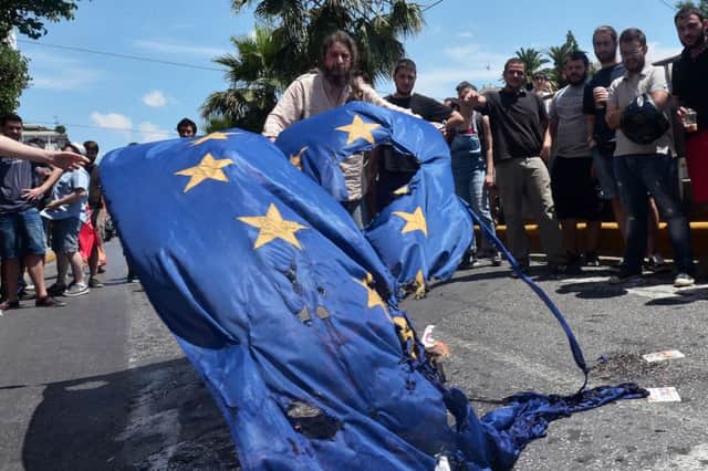 Leftwing protesters burn a European Union flag in Athens yesterday. Picture: Getty