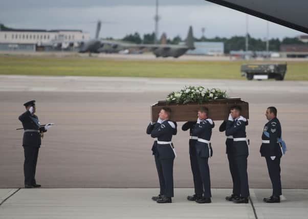 The coffin of Ann McQuire is taken from the RAF C-17 aircraft after it landed at RAF Brize Norton carrying nine of the victims of last Friday's terrorist attack in Tunisia. Picture: Getty Images