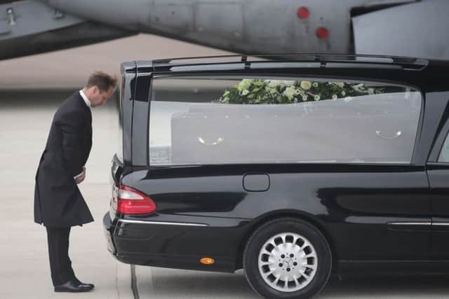 The coffin of Ann McQuire  is taken from the RAF C-17. Picture: PA