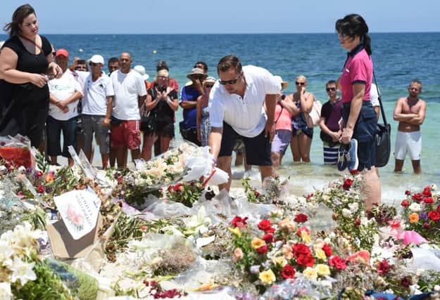 Tourists lay flowers on the beach at Sousse a week after a jihadist gunman killed 38 tourists, 30 of them British. Picture: Getty