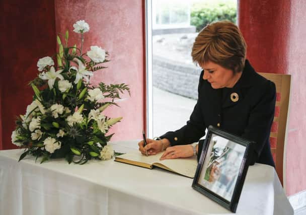 Nicola Sturgeon signs a book of condolence at the headquarters of North Lanarkshire Council in Motherwell where she joined others to observe the minute's silence for the victims of last Friday's shooting in Tunisia. Picture: PA