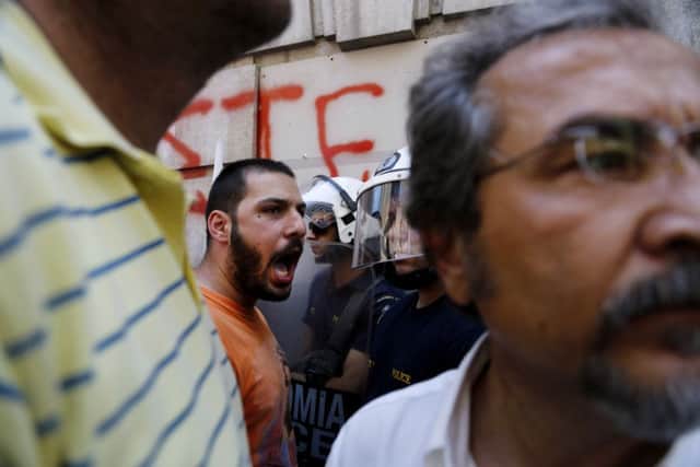 Greeks are campaigning hard for both sides in tomorrows referendum, but how that will affect UK investors in the long run is less clear. Picture: AP